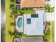 Aerial view of home featuring a screened in pool, solar panels, and a lake view at 1712 Boat Launch Rd, Kissimmee, FL 34746