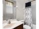 Traditional bathroom with a single sink vanity and a shower and tub combination with a decorative shower curtain at 1712 Boat Launch Rd, Kissimmee, FL 34746