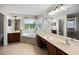 Bright bathroom featuring a tiled soaking tub, dual vanities, and glass-enclosed shower at 1712 Boat Launch Rd, Kissimmee, FL 34746