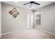 Bright bedroom with a ceiling fan, neutral carpet, and decorative artwork on the wall at 1712 Boat Launch Rd, Kissimmee, FL 34746