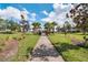 Scenic community walkway with manicured landscaping and mature trees, perfect for an evening stroll at 1712 Boat Launch Rd, Kissimmee, FL 34746