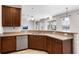 Kitchen featuring stainless steel appliances, wooden cabinetry, and granite countertops at 1712 Boat Launch Rd, Kissimmee, FL 34746