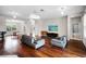 Spacious living room with hardwood floors, stylish furnishings, and modern lighting fixtures at 1712 Boat Launch Rd, Kissimmee, FL 34746