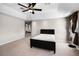 A bright main bedroom featuring carpet flooring, a bed, and large windows with draperies at 1712 Boat Launch Rd, Kissimmee, FL 34746