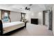 Spacious main bedroom with a ceiling fan, neutral carpet, and ensuite bathroom at 1712 Boat Launch Rd, Kissimmee, FL 34746