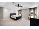 Main bedroom with a tray ceiling, a ceiling fan, and an upholstered bedframe at 1712 Boat Launch Rd, Kissimmee, FL 34746