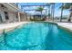 Sparkling pool in a screened enclosure, complemented by waterfront views at 1712 Boat Launch Rd, Kissimmee, FL 34746