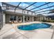 Backyard oasis with a screened-in pool, patio seating, and lush landscaping at 1712 Boat Launch Rd, Kissimmee, FL 34746