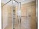 Tiled walk-in shower with glass enclosure, chrome hardware and tiled surround at 1712 Boat Launch Rd, Kissimmee, FL 34746