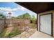 A small backyard with a privacy fence, partial stone paver, and a white back door at 1826 Warringwood Dr # B-1, Orlando, FL 32839