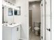 Bathroom with white vanity, mirror, and toilet at 1826 Warringwood Dr # B-1, Orlando, FL 32839