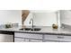 Close-up on kitchen counter with sink and stainless steel dishwasher with granite countertops at 1826 Warringwood Dr # B-1, Orlando, FL 32839
