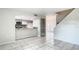 Open-concept living space with tile flooring and a view of the modern kitchen at 1826 Warringwood Dr # B-1, Orlando, FL 32839