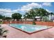 Outdoor swimming pool surrounded by fencing with mature trees and apartment buildings in the background at 1826 Warringwood Dr # B-1, Orlando, FL 32839