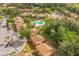 An aerial view of community buildings, parking, mature trees and a community pool at 190 Hickory Woods Ct # 12B, Deltona, FL 32725