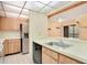 Functional kitchen featuring wood breakfast bar with views to living room at 190 Hickory Woods Ct # 12B, Deltona, FL 32725
