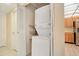 Laundry area featuring a stacked washer/dryer unit and shelving, conveniently located near the kitchen at 190 Hickory Woods Ct # 12B, Deltona, FL 32725