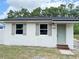 Charming home featuring a tidy front lawn, updated windows with classic shutters and a freshly painted front door at 1921 Nw 12Th St, Ocala, FL 34475
