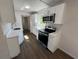 Bright kitchen with sleek, white cabinets, stainless steel appliances, and modern countertops, complemented by durable flooring at 1921 Nw 12Th St, Ocala, FL 34475