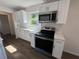 Well-lit kitchen featuring new stainless steel appliances, white cabinets, and modern countertop design for a clean, updated look at 1921 Nw 12Th St, Ocala, FL 34475