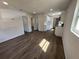 Spacious living room featuring updated flooring, neutral paint, and ample natural light, flowing seamlessly into the modern kitchen at 1921 Nw 12Th St, Ocala, FL 34475
