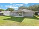 Green backyard with a patio and a view of the house at 205 Lori Ct, Umatilla, FL 32784