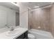 Cozy bathroom featuring neutral-tiled walk-in shower, a toilet, and a single sink vanity at 205 Lori Ct, Umatilla, FL 32784