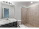 Tiled bathroom featuring a walk-in shower, toilet, and single sink vanity at 205 Lori Ct, Umatilla, FL 32784