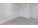 Neutral bedroom featuring plush carpeting and a double door closet for ample storage at 205 Lori Ct, Umatilla, FL 32784