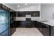 Well-equipped kitchen featuring black appliances and sleek black cabinets at 205 Lori Ct, Umatilla, FL 32784