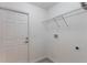 Functional laundry room with overhead shelving and hookups for appliances at 205 Lori Ct, Umatilla, FL 32784