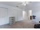 Spacious bedroom featuring carpeting, natural light, and multiple closets at 205 Lori Ct, Umatilla, FL 32784