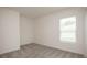 Bright, minimalist bedroom with plush carpeting and a window offering natural light at 2144 Hibiscus Pl, Kissimmee, FL 34759