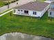 Backyard with lush green lawn, and a view of the house with a covered patio at 2152 Rock Maple Bnd, Kissimmee, FL 34746