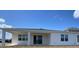 Exterior view of the home's rear, including a covered patio area and lush green grass at 2152 Rock Maple Bnd, Kissimmee, FL 34746