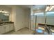 Elegant bathroom with double sinks, a glass-enclosed shower, and neutral-toned tiling at 2152 Rock Maple Bnd, Kissimmee, FL 34746