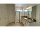 Well-lit bathroom showcasing a glass shower, modern vanity, and neutral color scheme at 2152 Rock Maple Bnd, Kissimmee, FL 34746