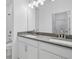 Modern bathroom featuring double vanity with gray countertop and white cabinets at 2152 Rock Maple Bnd, Kissimmee, FL 34746