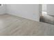 Bedroom features sleek wood-look tile flooring and bright white walls at 2152 Rock Maple Bnd, Kissimmee, FL 34746
