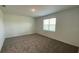 Spacious bedroom with neutral-colored carpet and a large window offering plenty of natural light at 2152 Rock Maple Bnd, Kissimmee, FL 34746