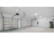 Spacious three-car garage featuring two automatic overhead doors at 2152 Rock Maple Bnd, Kissimmee, FL 34746