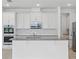 Bright kitchen features stainless appliances, center island, and stylish backsplash at 2152 Rock Maple Bnd, Kissimmee, FL 34746