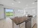 Kitchen island with stainless steel appliances and a sink that is designed for modern living at 2152 Rock Maple Bnd, Kissimmee, FL 34746
