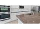 Modern kitchen with stainless steel appliances, gray countertops, and attractive backsplash at 2152 Rock Maple Bnd, Kissimmee, FL 34746