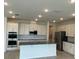 Modern, bright kitchen with stainless steel appliances, a large island, and ample cabinet space at 2152 Rock Maple Bnd, Kissimmee, FL 34746