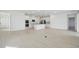 Spacious open-concept living area flows into the kitchen with sleek flooring and recessed lighting at 2152 Rock Maple Bnd, Kissimmee, FL 34746