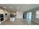 Open-concept living area featuring a modern kitchen, stainless appliances and sliding door to backyard at 2152 Rock Maple Bnd, Kissimmee, FL 34746