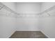 Empty walk-in closet with carpet and wire rack shelving perfect for organizing clothes and accessories at 2152 Rock Maple Bnd, Kissimmee, FL 34746