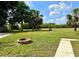 Expansive backyard featuring a fire pit and lush greenery for outdoor enjoyment and privacy at 2155 Palm View Dr, Apopka, FL 32712