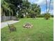 Expansive backyard featuring a brick fire pit, mature palm trees, and ample space for outdoor enjoyment at 2155 Palm View Dr, Apopka, FL 32712